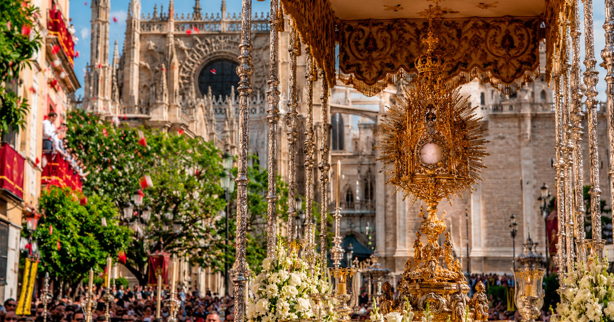 Procesión del Corpus Christi por las calles de Sevilla con el Santísimo Sacramento bajo palio.